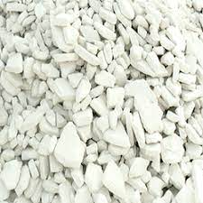 Pile of white kaolin clay with fine texture, used in ceramics, paper coating, paints and industrial applications.