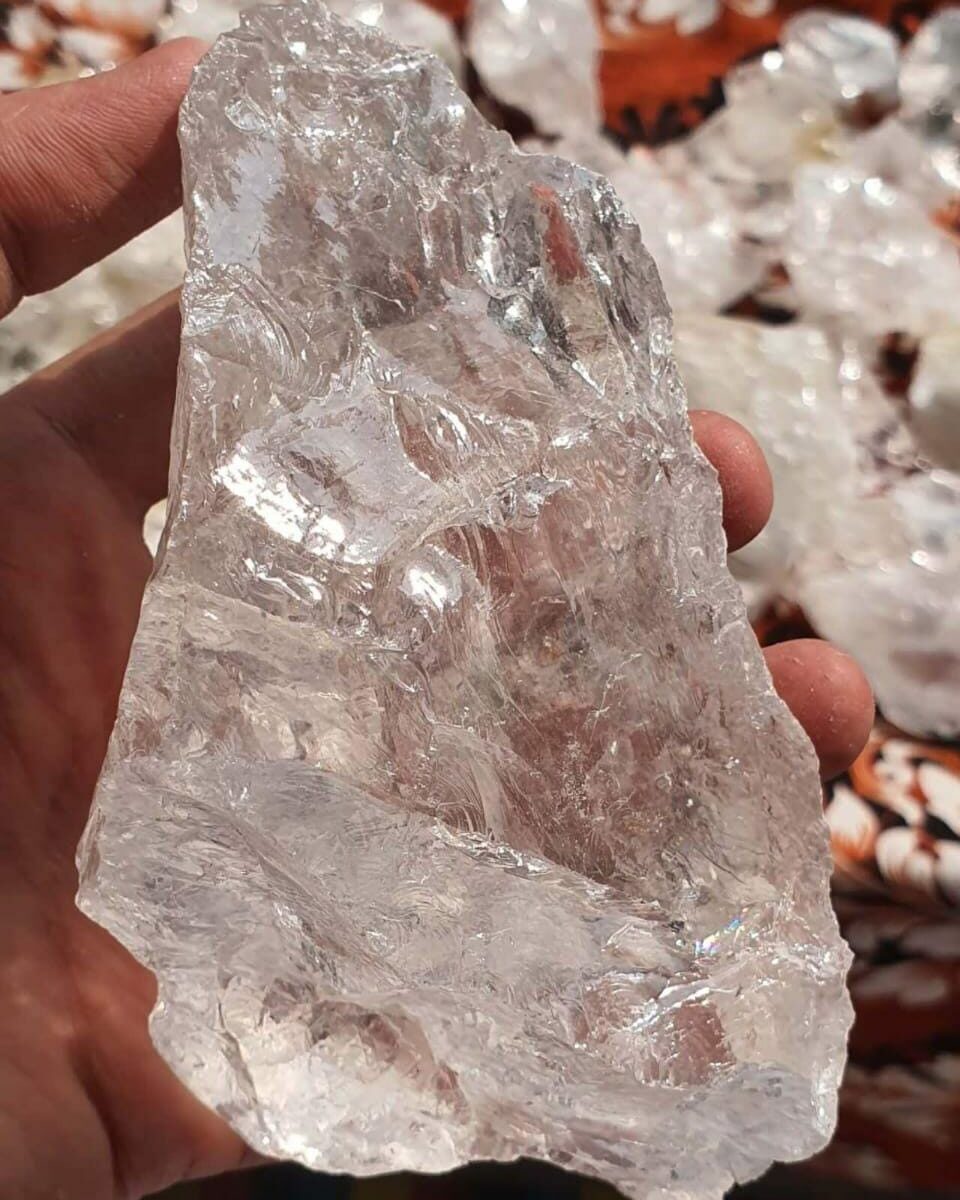 Clear quartz crystal in raw transparent form used for jewelry, decoration, glass manufacturing and industrial applications.